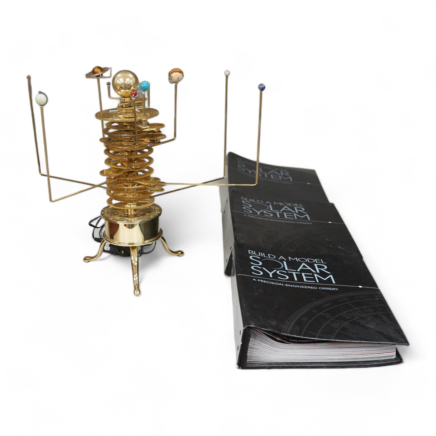 A precision brass orrery, a kit built electric operated astronomical orrery issued by Eaglemoss Publications as a part work ‘Build a Model Solar System’, complete with hardstone planets, brass moons, and a complete run o